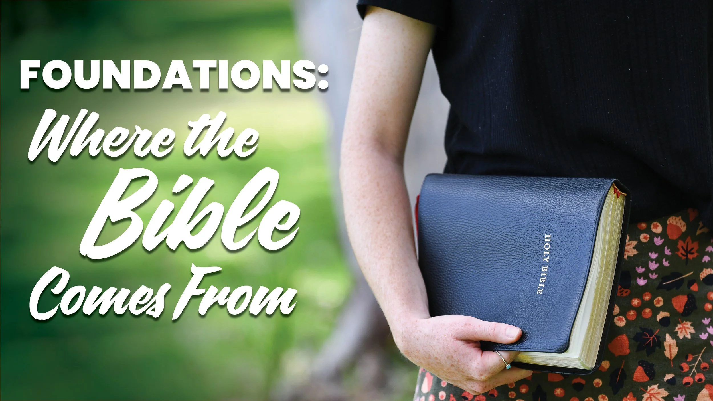 A woman holding a bible in her right hand.