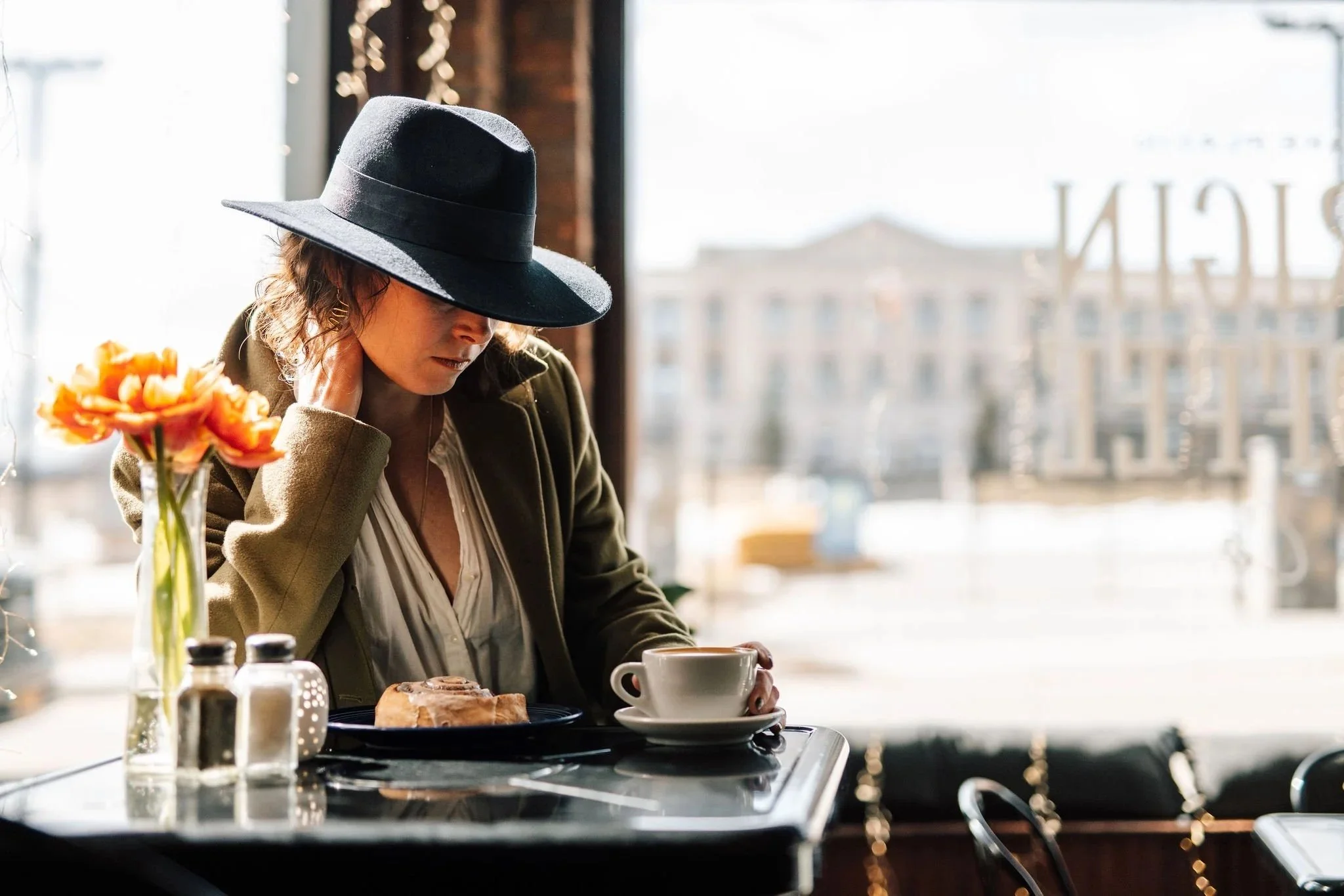Woman in hat sitting in coffee shop