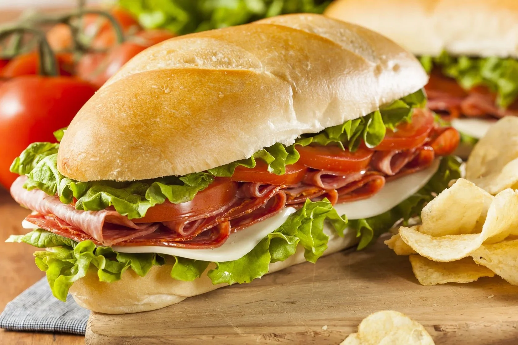 Big sub sandwich with meat, cheese and veggies.
