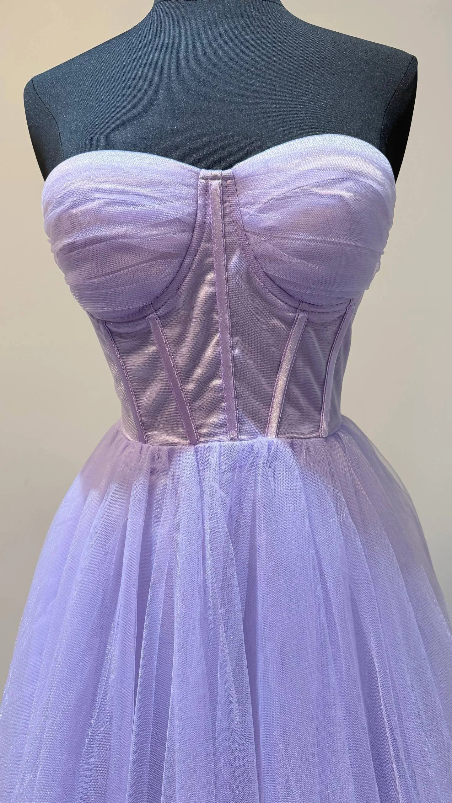 A lavender-colored strapless dress displayed on a mannequin against a plain background.