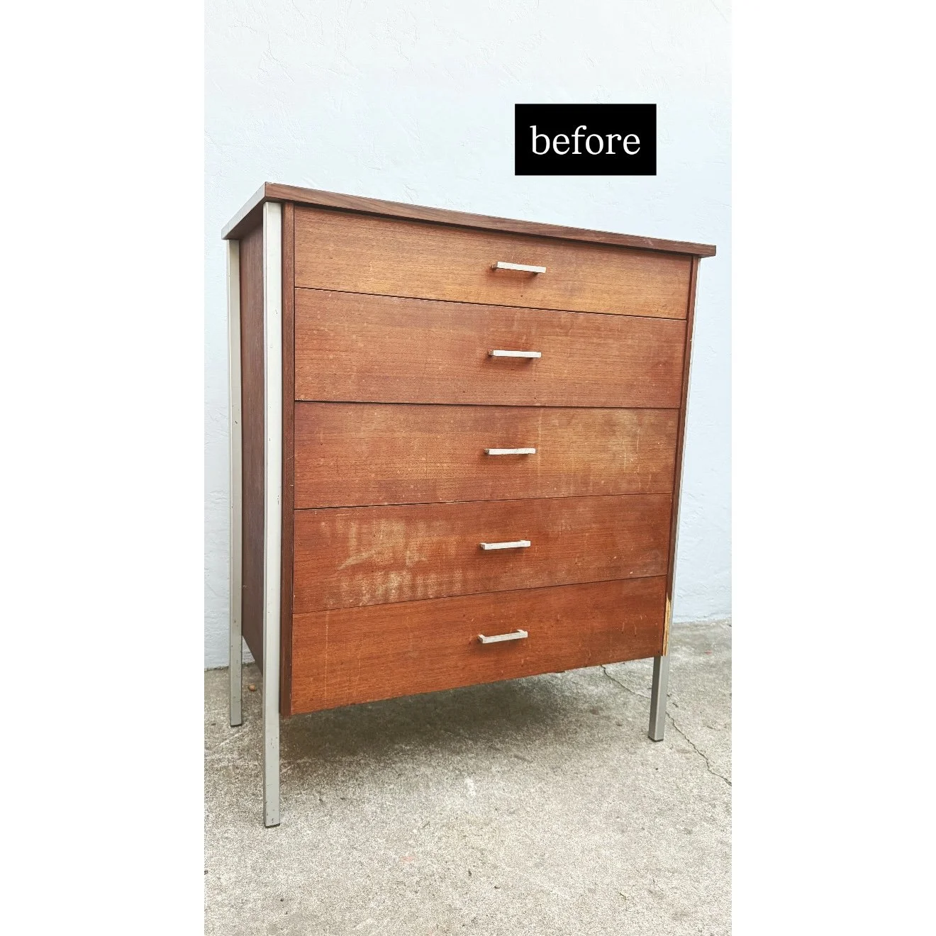 A wooden dresser with five drawers and silver handles, standing on metal legs against a white wall, labeled 'before'.