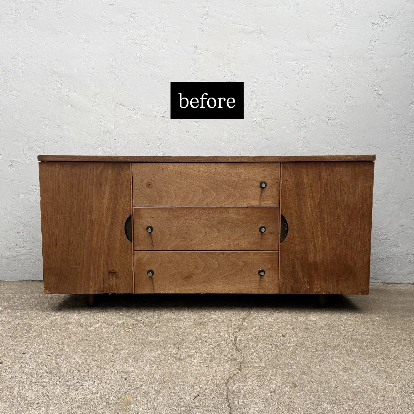 A wooden sideboard with three drawers and two cabinets, placed against a textured white wall. The photo is labeled 'before'.