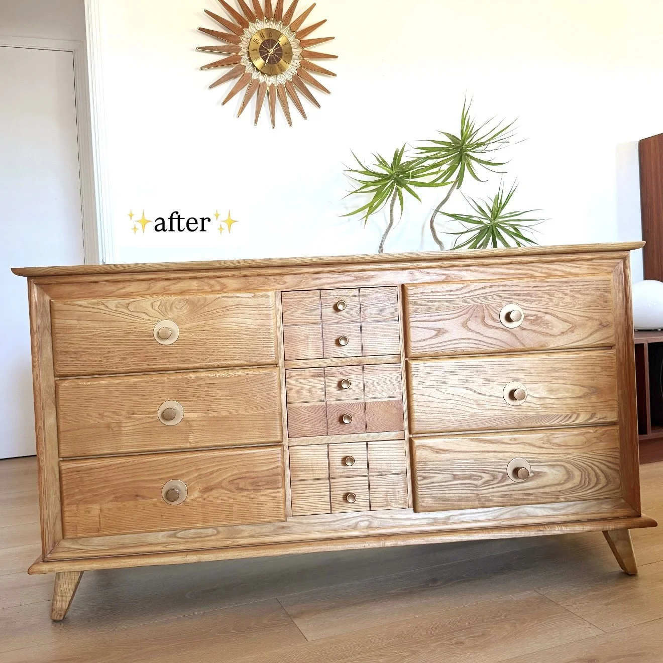 Wooden dresser with multiple drawers in a mid-century modern style, with a large sunburst mirror and green plant in the background, labeled 'after' in the image.