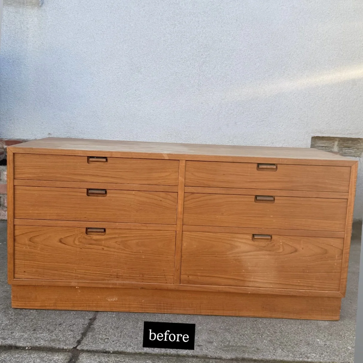 A wooden dresser with six drawers, placed outdoors against a wall, labeled 'before'.
