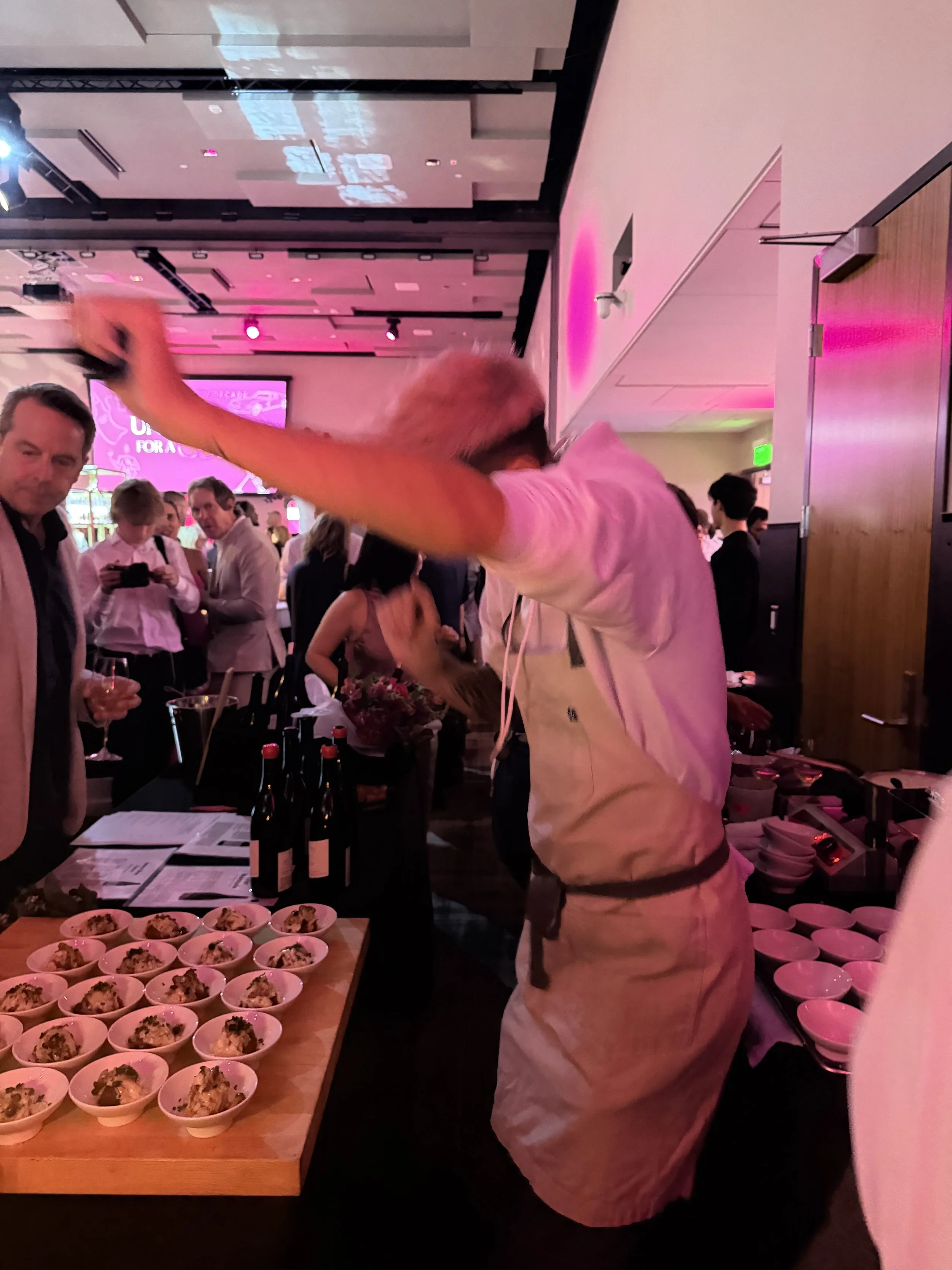 Chef Ben dancing at the 2026 Uncork for a Cure Event  with Madeline Triffon and Ann Delisi