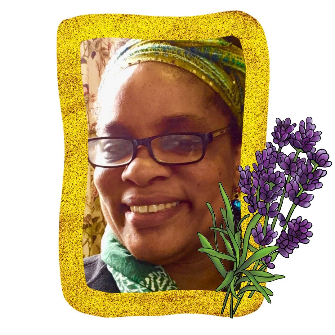 A headshot of Renee Hill - she is wearing a beautiful green patterned head dressing and black glasses with rectangular frames.