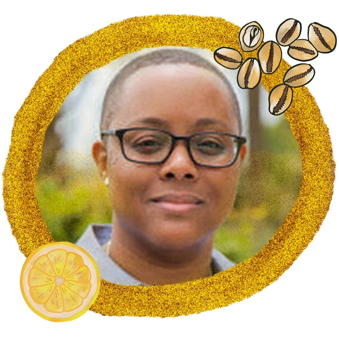 A heeadshot of Carla Gaskins-Nathan - she wears stud earrings and black glasses with rectangular frames.