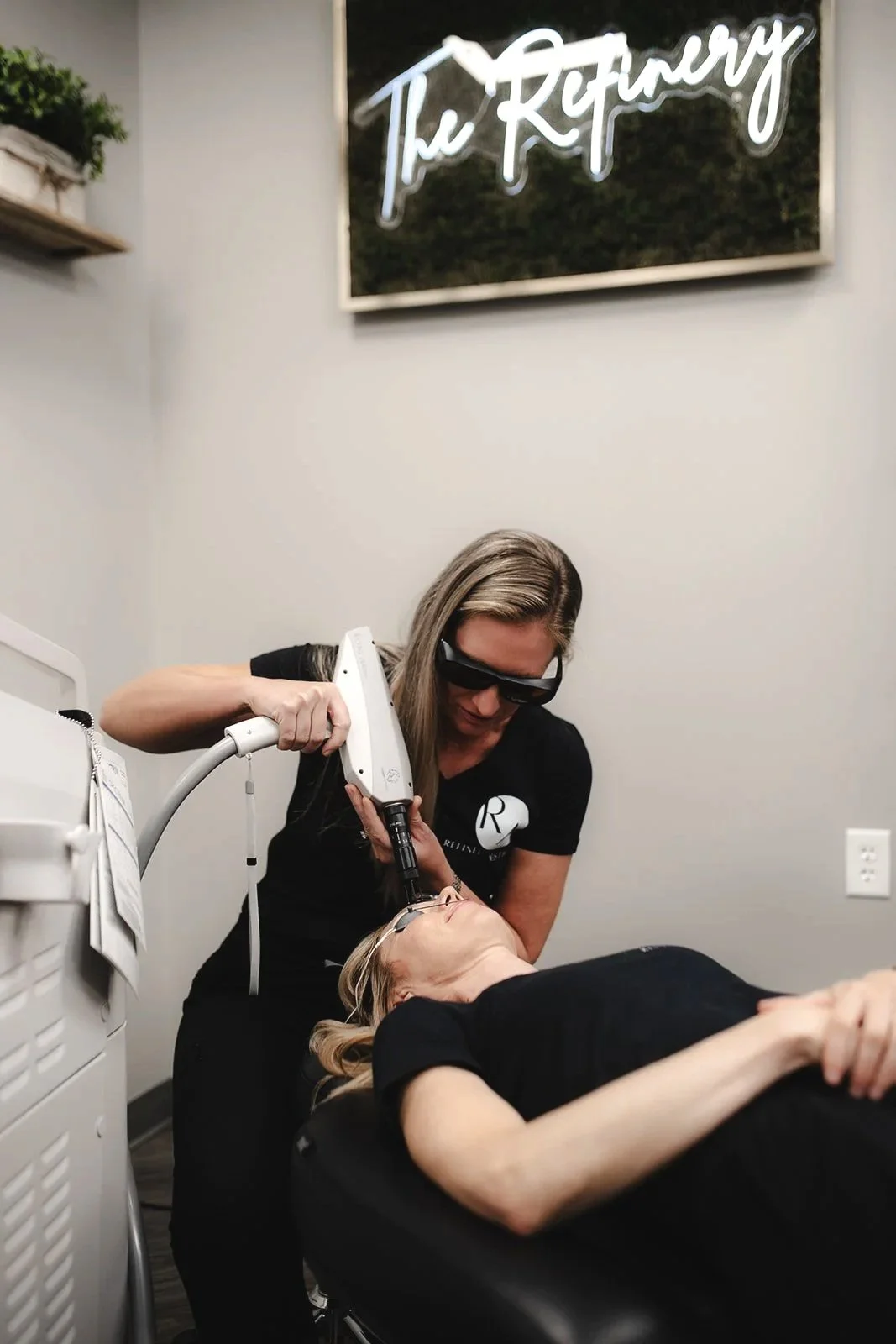 A person holding a white glue gun against a plain white background.