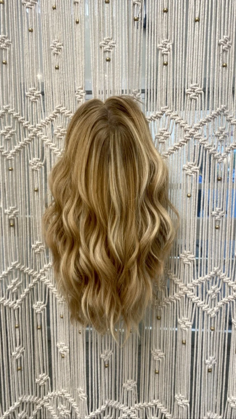 Long blonde wig styled by Hair By Liza