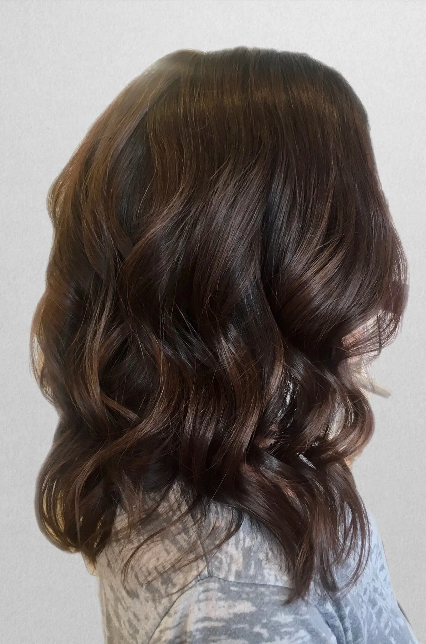 Dark brunette hair styled in soft waves