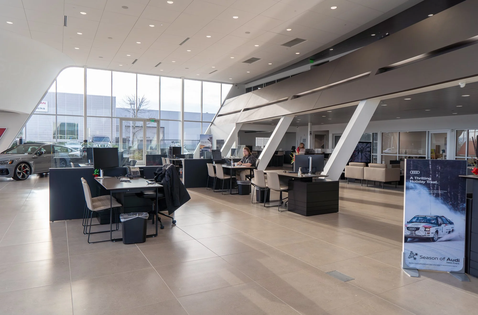 Modern retail showroom in Wilsonville, Oregon for Audi, featuring expansive floor-to-ceiling windows and a minimalist interior layout