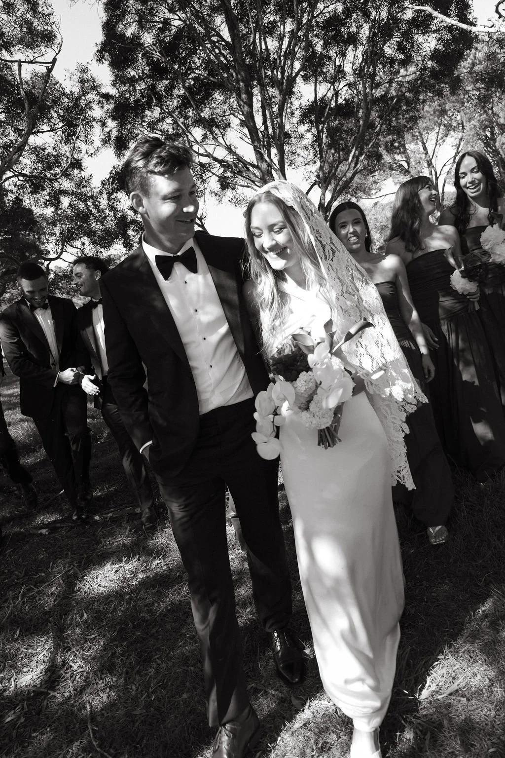 Emily and Mitch walking together after their Waiheke Island wedding ceremony