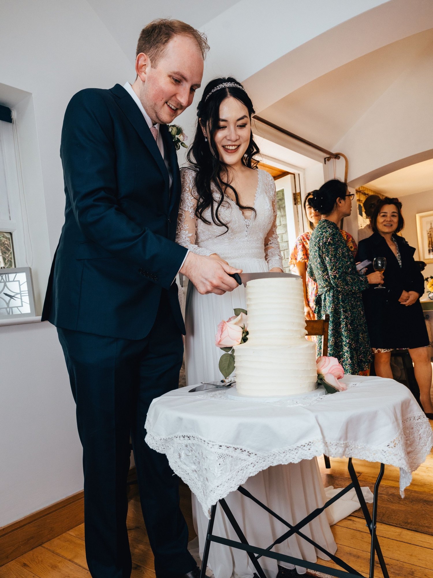 Bride and groom cutting their bespoke wedding cake by My Heavenly Cakes, Cambridge