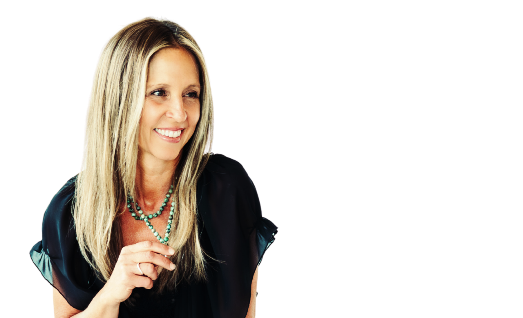 Smiling woman with long blonde hair wearing a black top, turquoise beaded necklace, and holding the necklace with her right hand.
