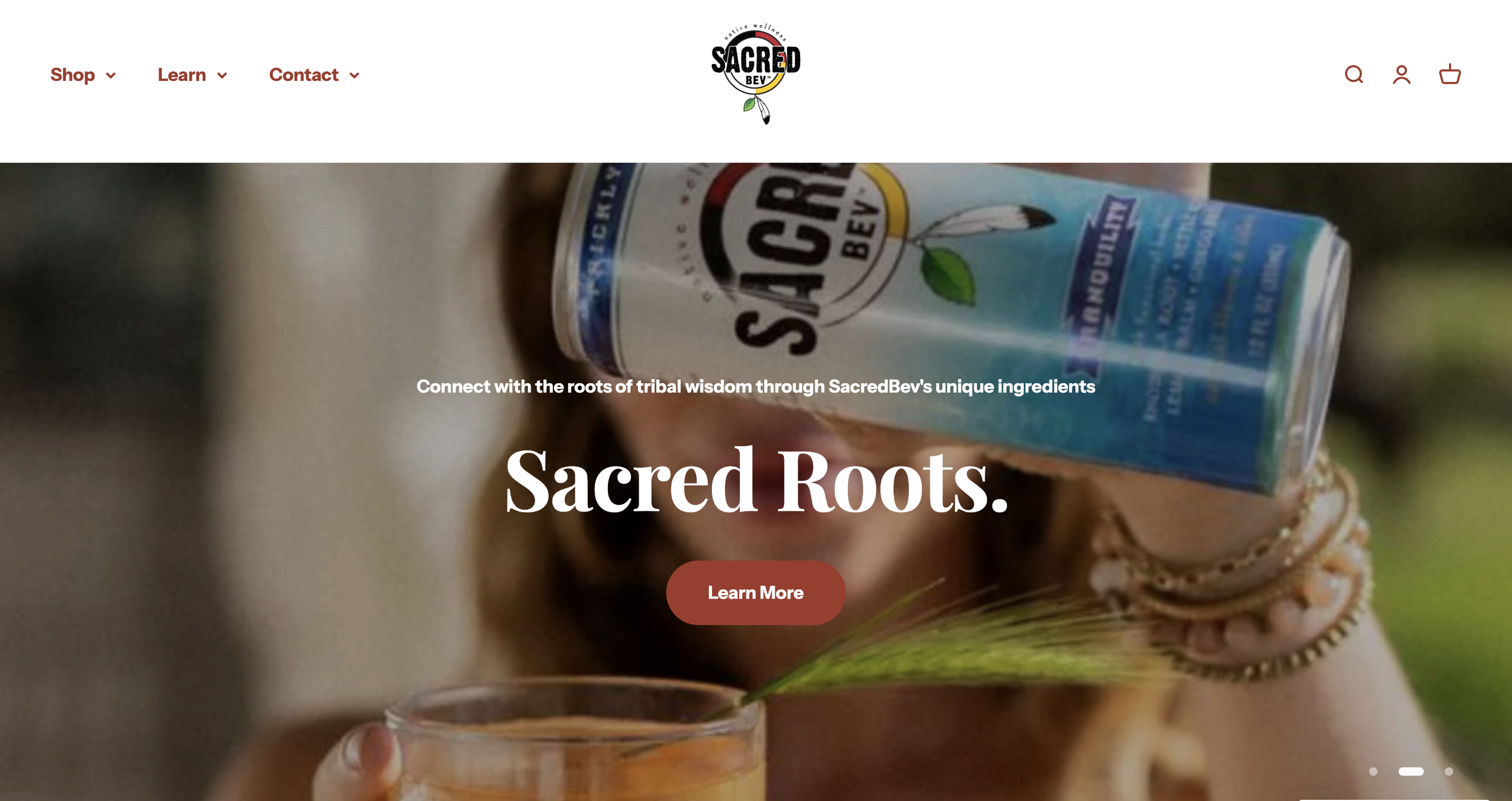 A person holding a SacredBev product bottle over a glass with a green leaf and beverage, with website text overlay about connecting with tribal wisdom through unique ingredients of Sacred Roots.