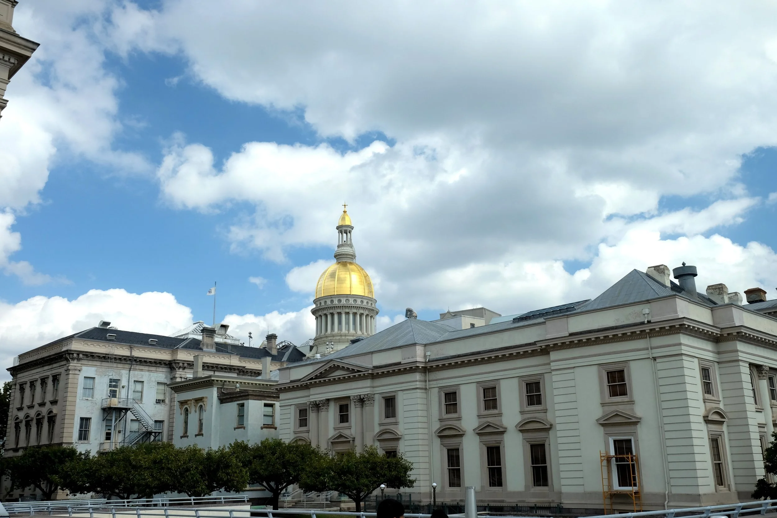 The New Jersey State Capitol building with a bright gold dome.