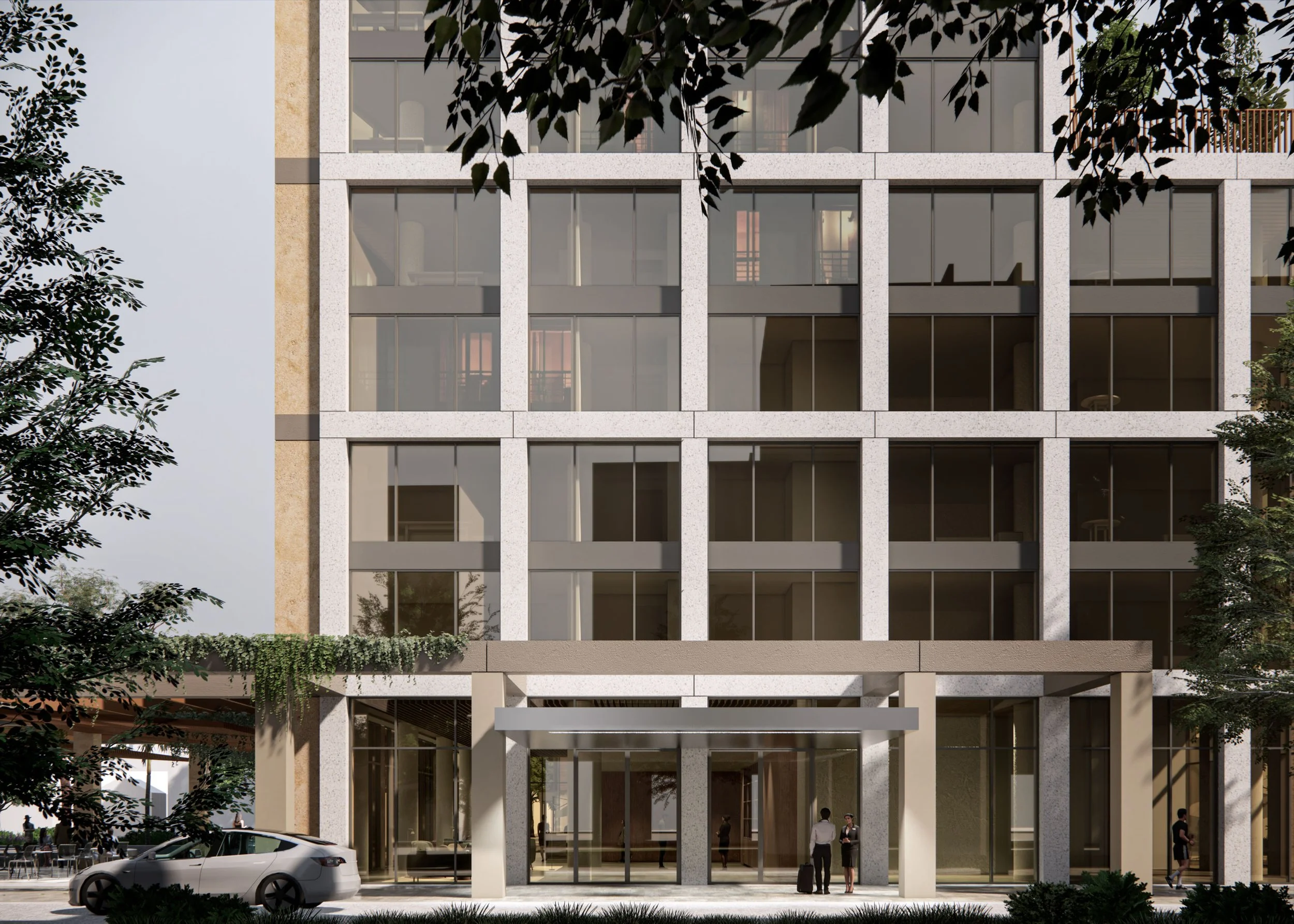 Modern multi-story office building with large glass windows, surrounded by trees and parked cars, with entrance doors and people standing outside.