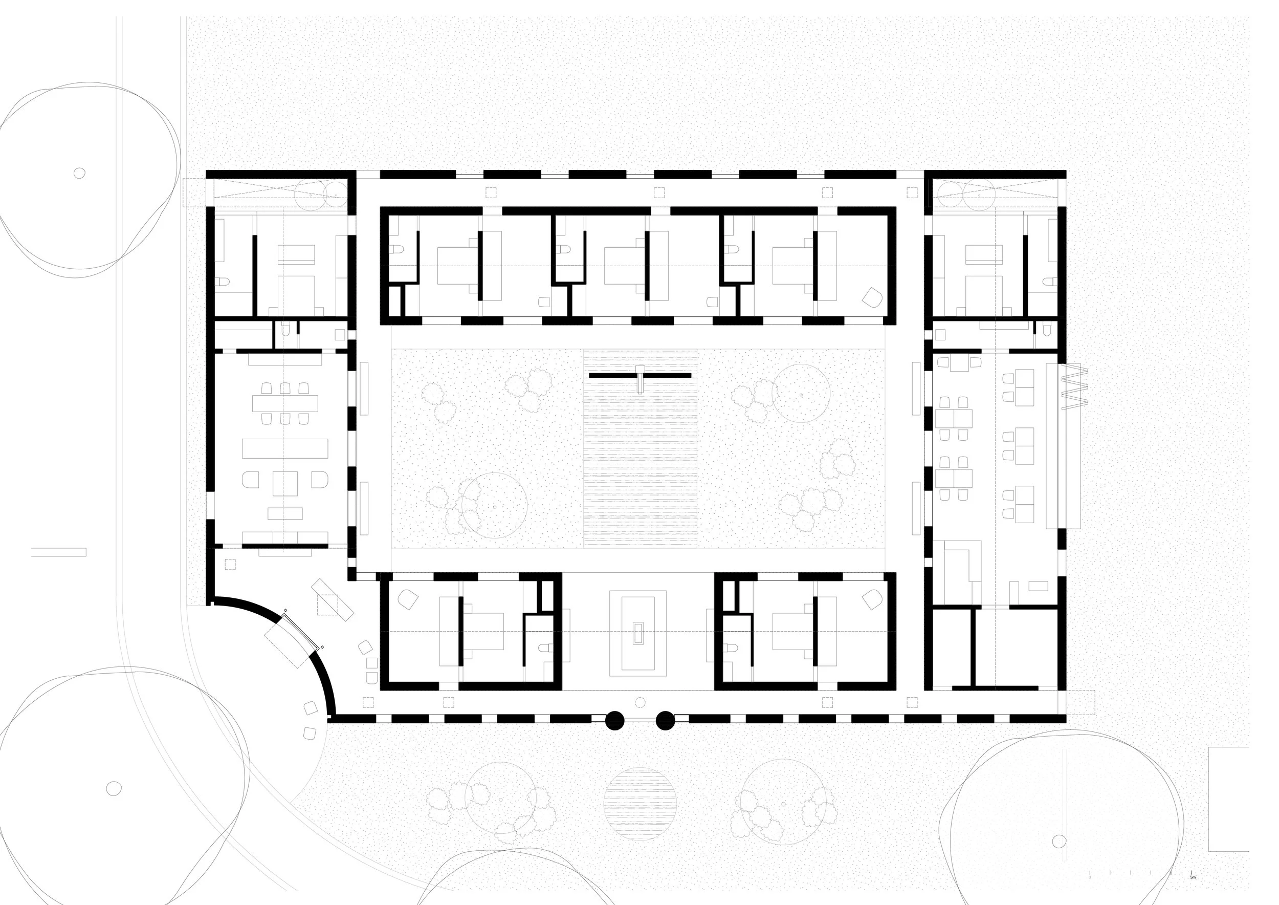 Architectural floor plan of a building with interior rooms, central outdoor courtyard with landscaping, and surrounding pathways.