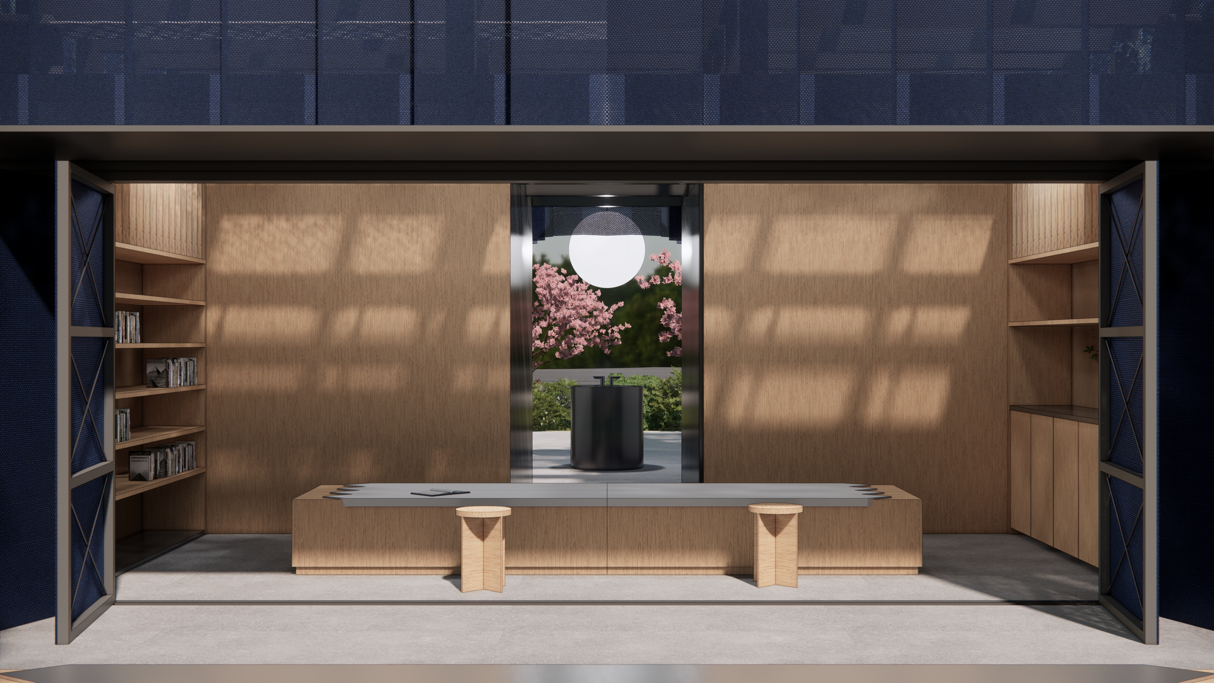 Interior view of a modern room with wooden walls and built-in shelves filled with books, illuminated by natural light through large glass doors, a bench in the center, and a view of pink cherry blossoms and a large circular sculpture outside.