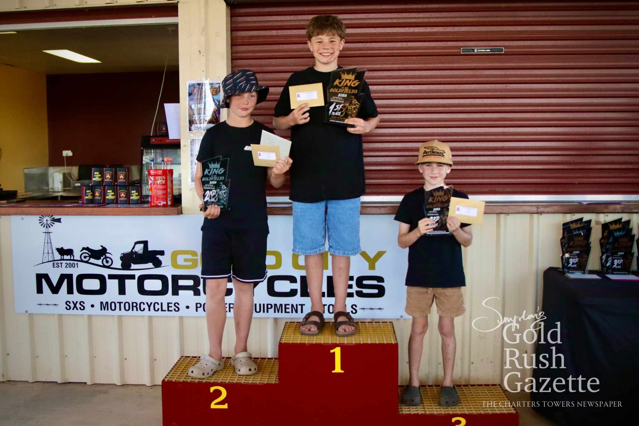 65cc 10-Under12 winners William Fapani (second), Beau Deschamp (first), and Axel O'Brien (third) at the 2026 King of the Goldfields awards presentation 