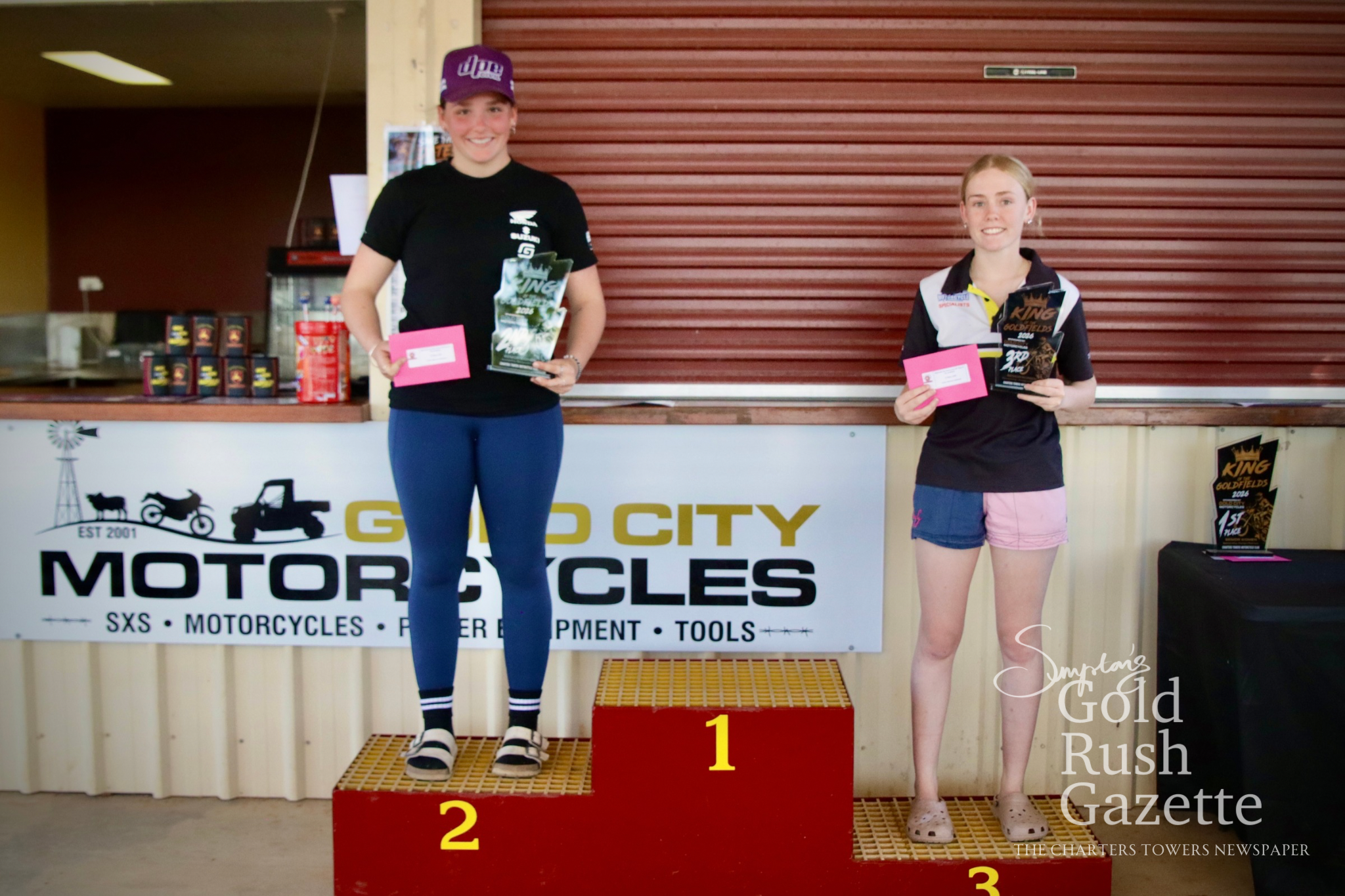 Senior women Stevie Williamson (second) and Kelly Davis (third) at the 2026 King of the Goldfields awards presentation hosted by the Charters Towers Motorcycle Club