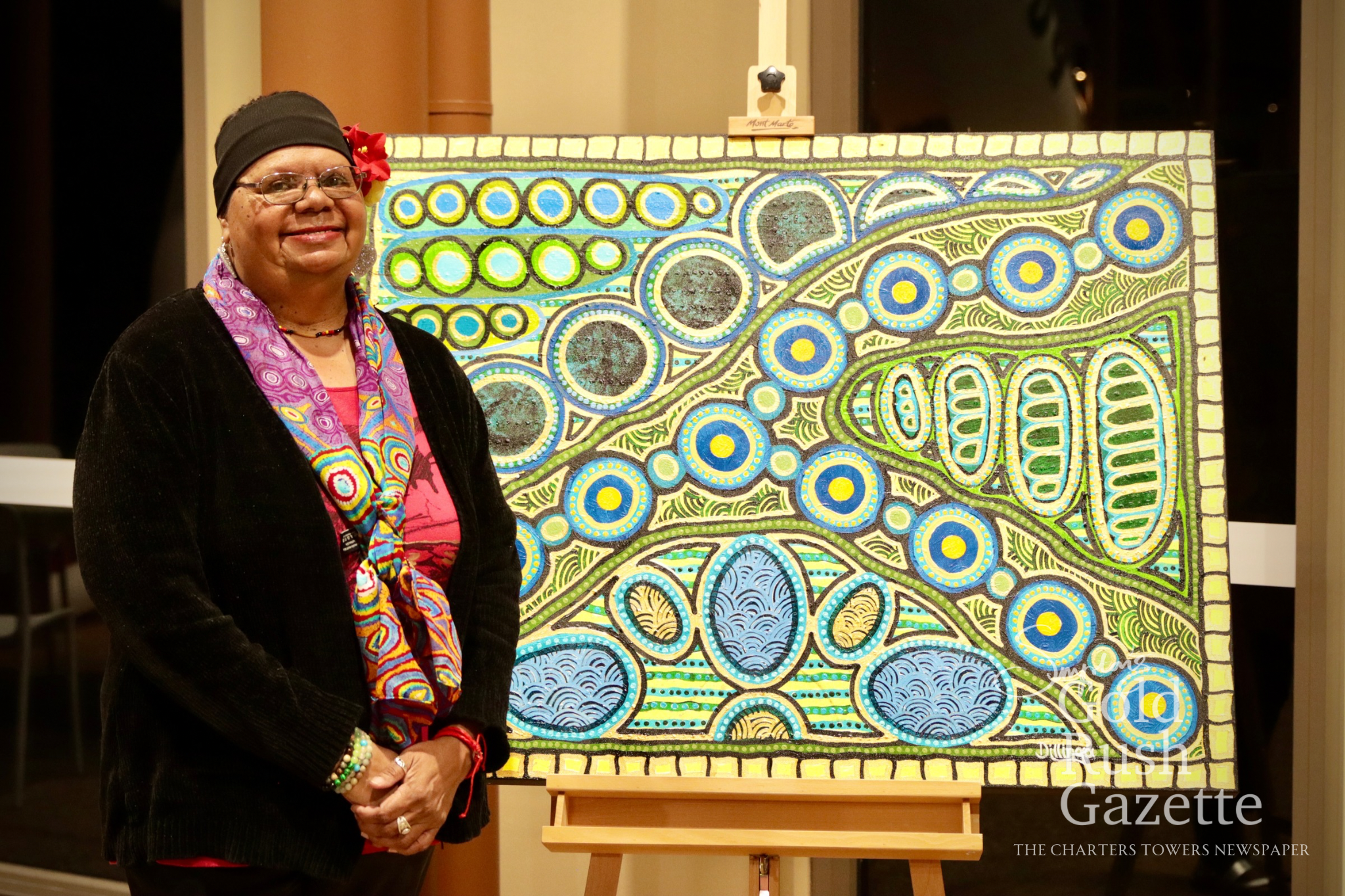Tania Ault of Dillinga's Dreaming and her work "Mulja (Burdekin River) - Muthin Derra (after the Rain)” at the Poppet Head Plaza Rotary NAIDOC Markets at Goldtower Central (2025)