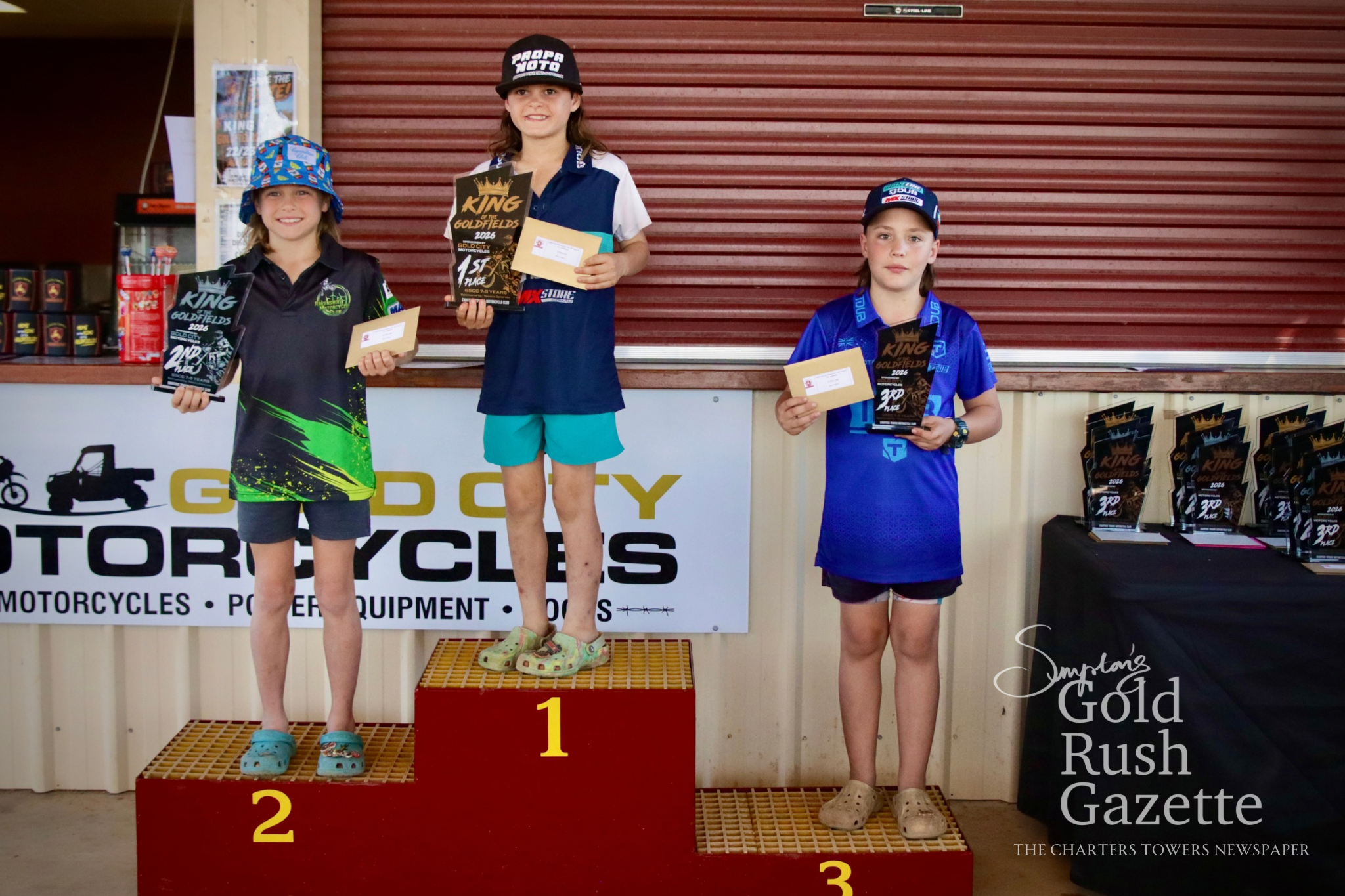 65cc 7-Under10 winners Benjamin Price (second), Zade Stemp (first), and Ty O'Halloran (third) at the 2026 King of the Goldfields awards presentation