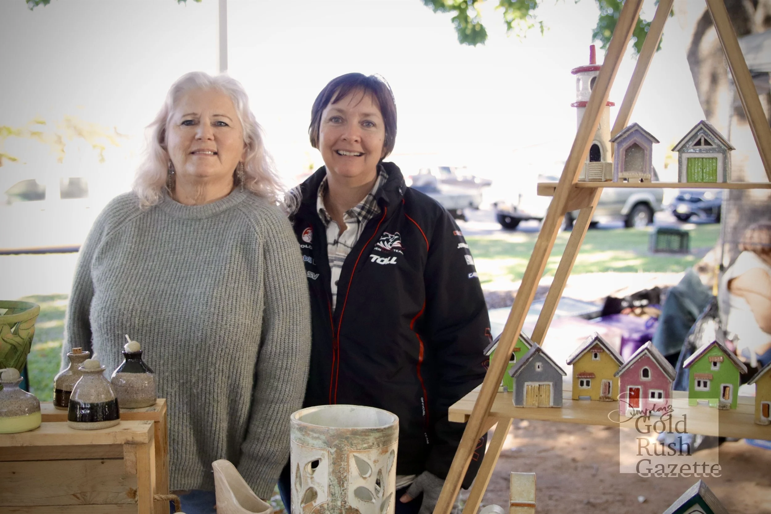 Jayne Sturmfels and Sue Orr at the June Centenary Park Charity Markets (ceramic houses made by Sian Rowe) (2024)
