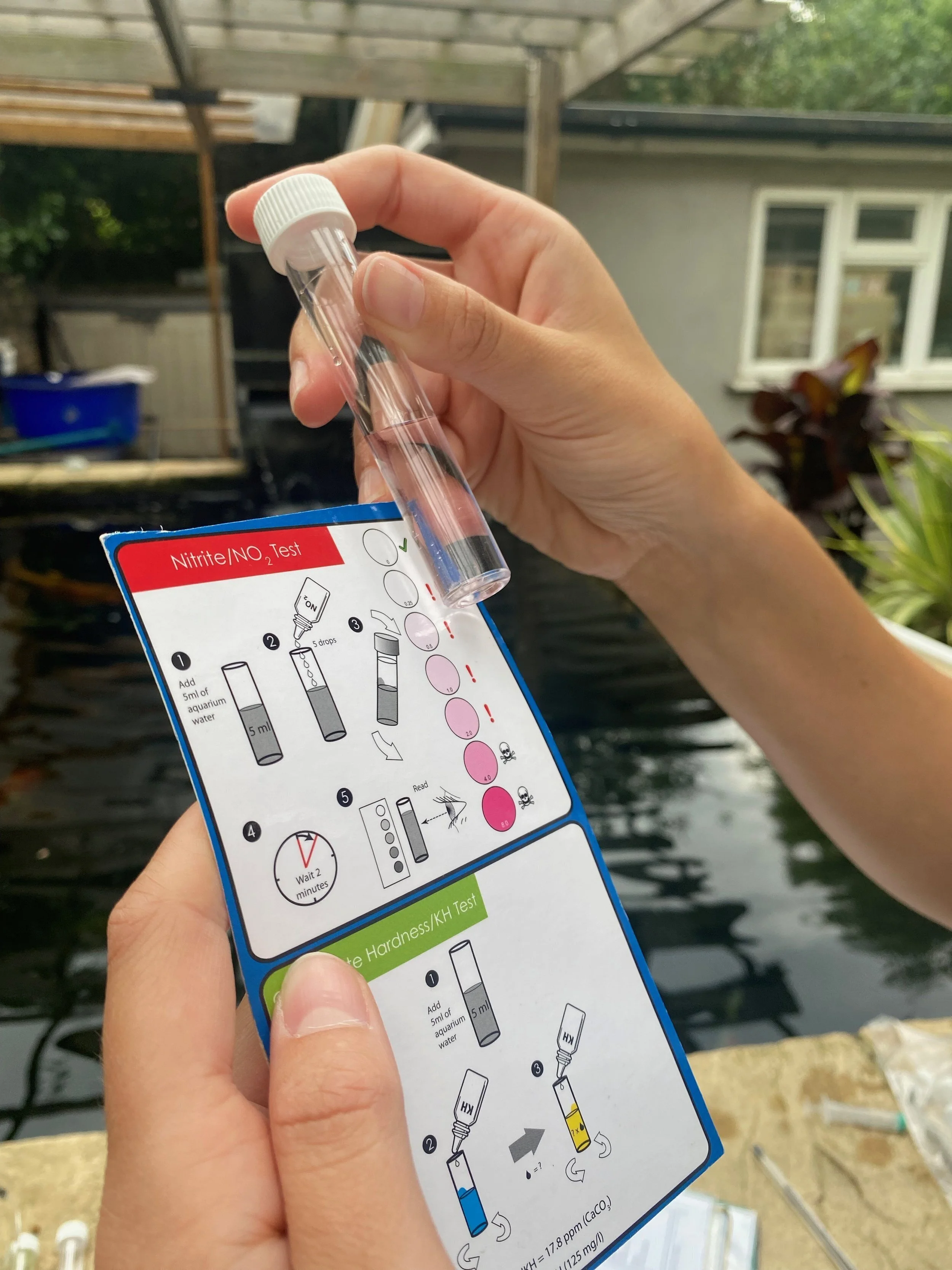 Hands holding instruction card and test tube