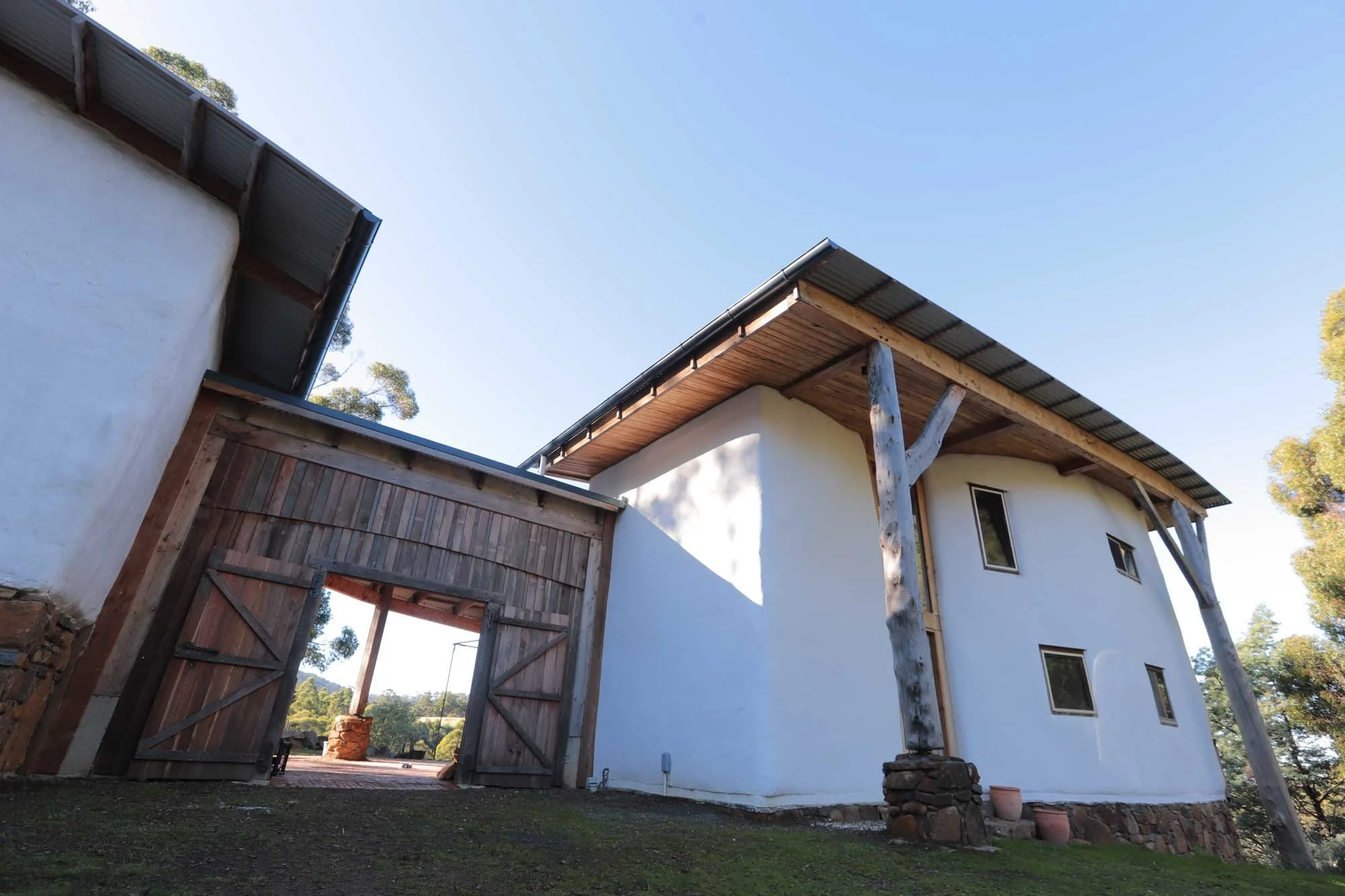 Huge timber braced, rendered straw bale. 