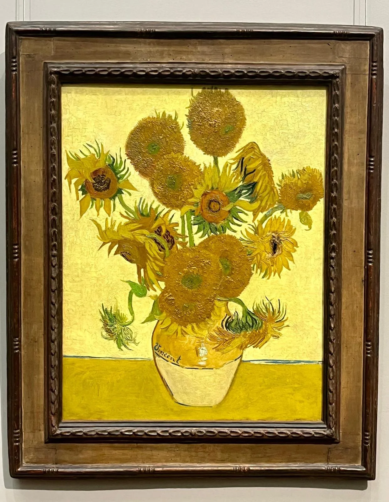 Vincent van Gogh’s Sunflowers, a famous still-life painting featuring vibrant yellow sunflowers in a vase, illustrating the history of yellow pigments in art.