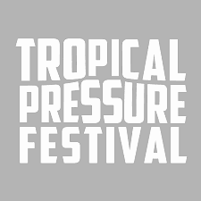 Text that reads 'Tropical Pressure Festival' on a gray background.