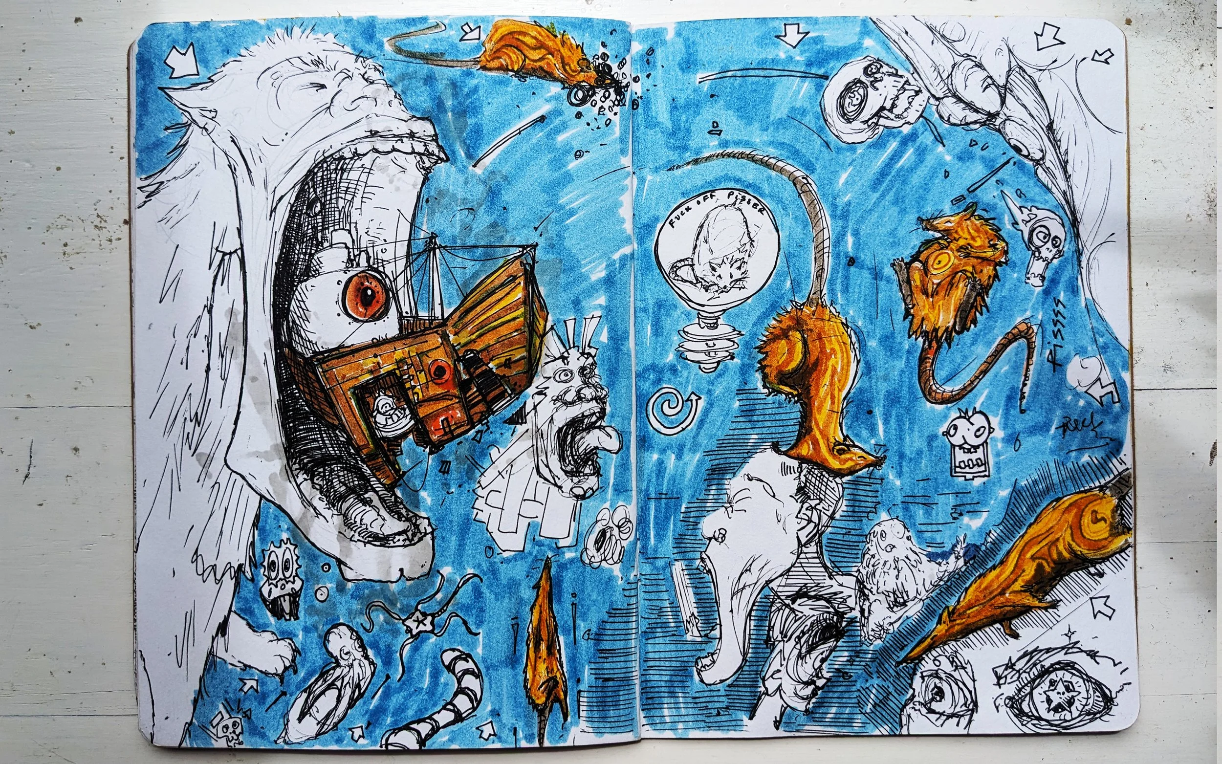 A sketchbook page with colorful ink drawings of various fantastical and whimsical creatures and characters, including a large creature with one eye and a ship inside its open mouth, a lion, a bird, and a snake, all set against a blue background.