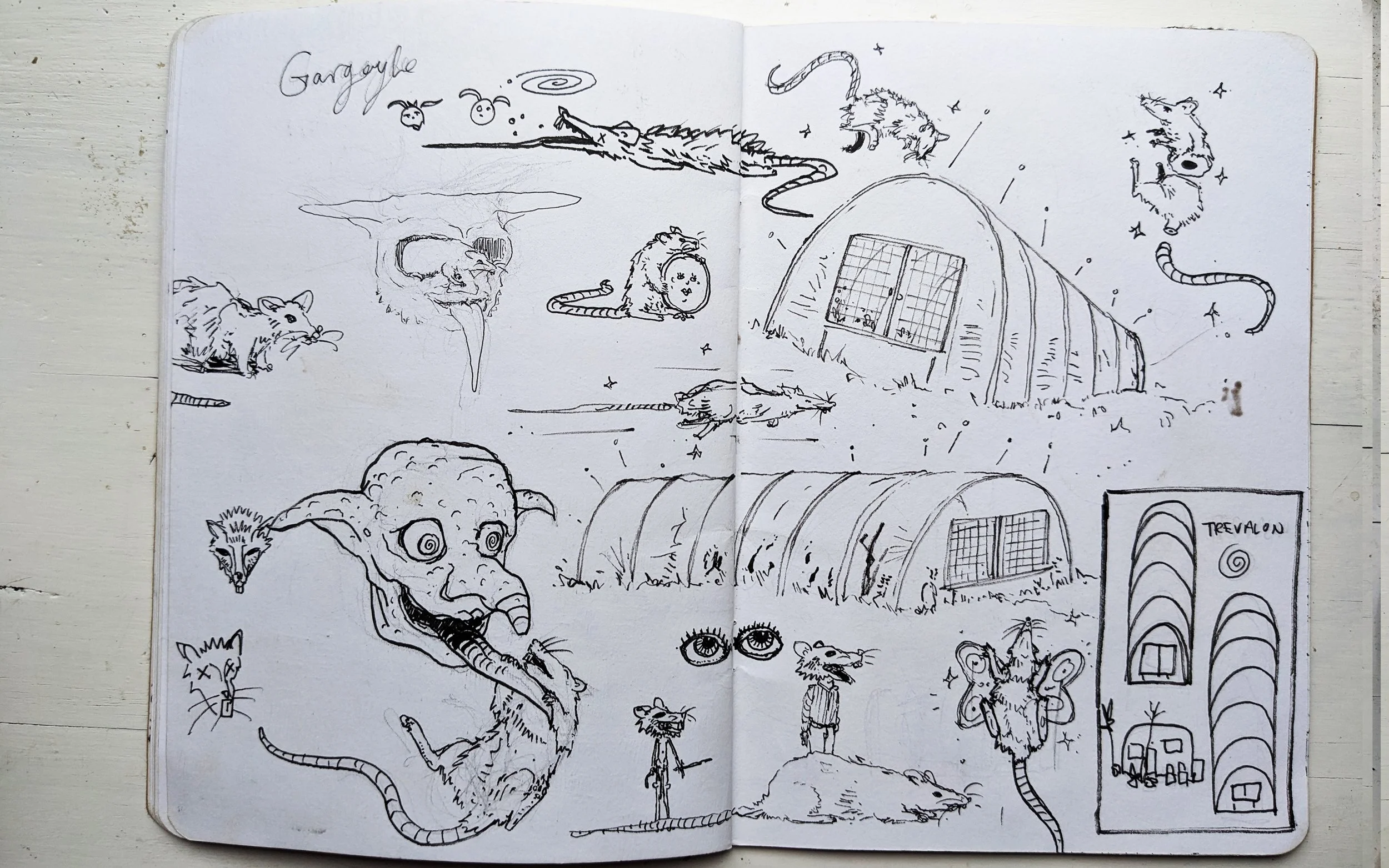 A sketchbook page filled with various black and white doodles including mice, a large rat, a dragon, and surreal mythical creatures. There are also drawings of a greenhouse, a structure labeled 'Trevallon,' and detailed eye sketches.
