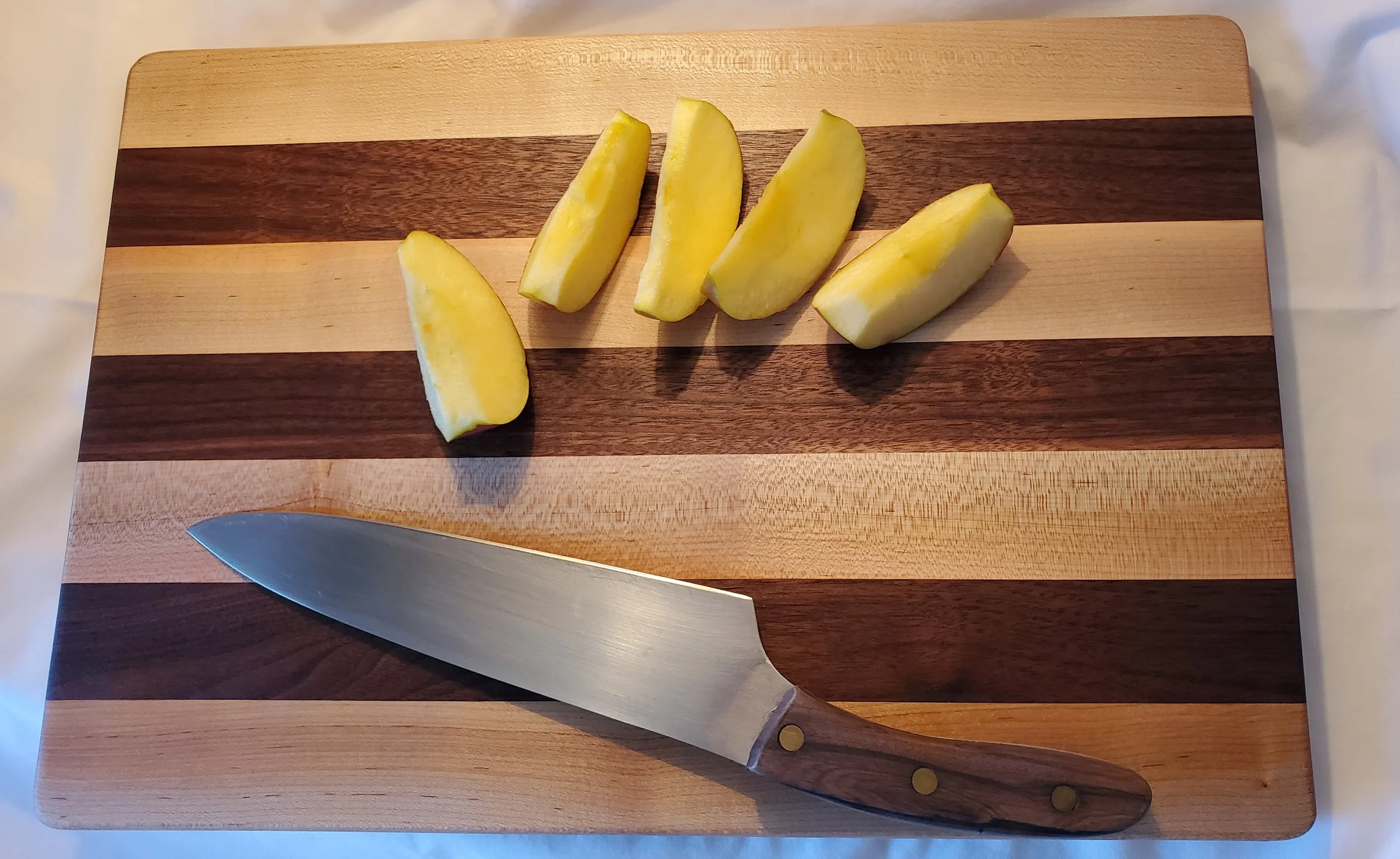 Two-Color Style cutting board is elegant in its simplicity.   
Shown, 11.5 inch wide by 17 inch long Full-sized Walnut and Maple Cutting Board Custom art work is free
