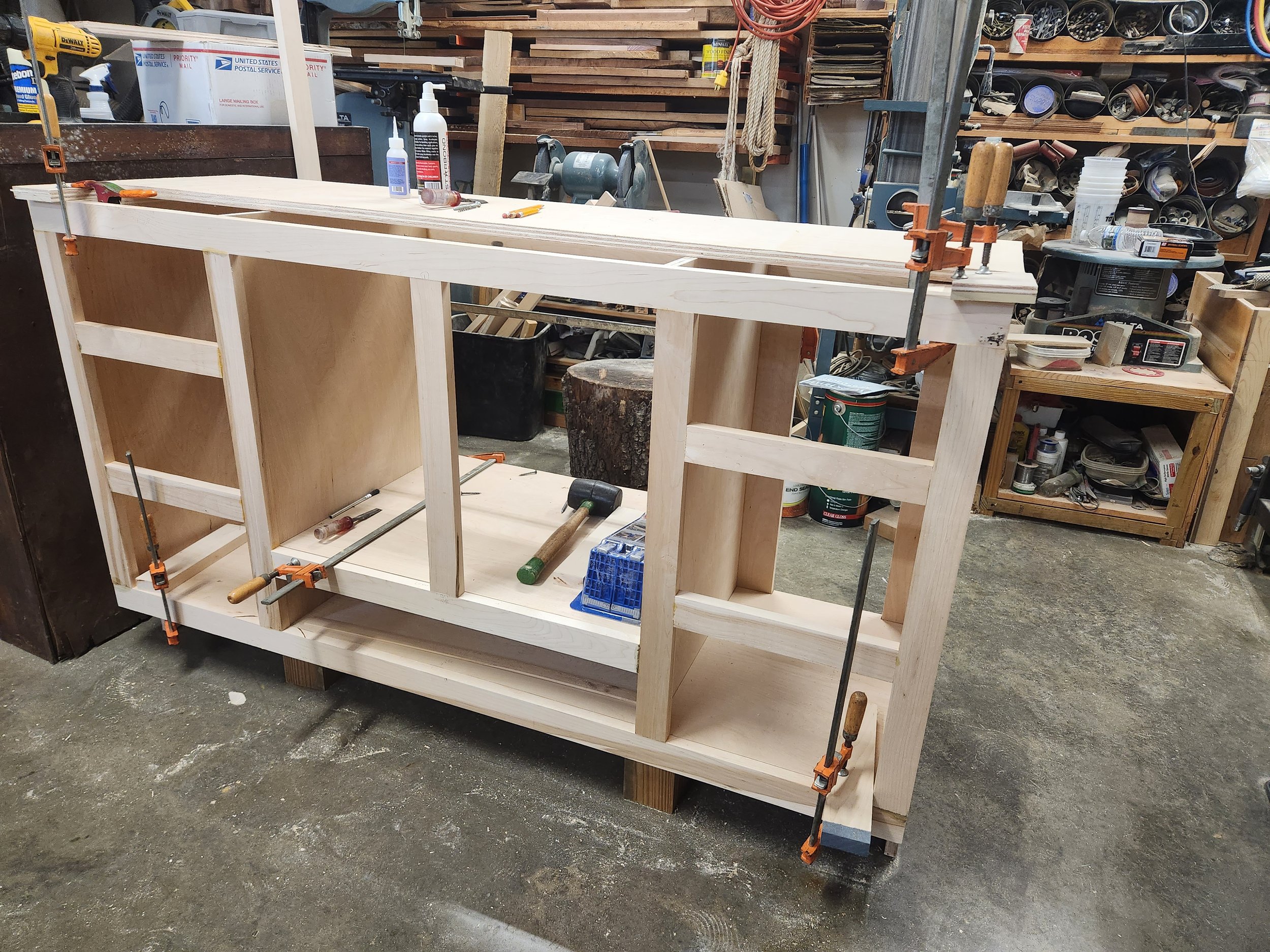 8-drawer cabinet face frame being test fitted before application.  
Note space for two drawers under sink space, a unique feature.