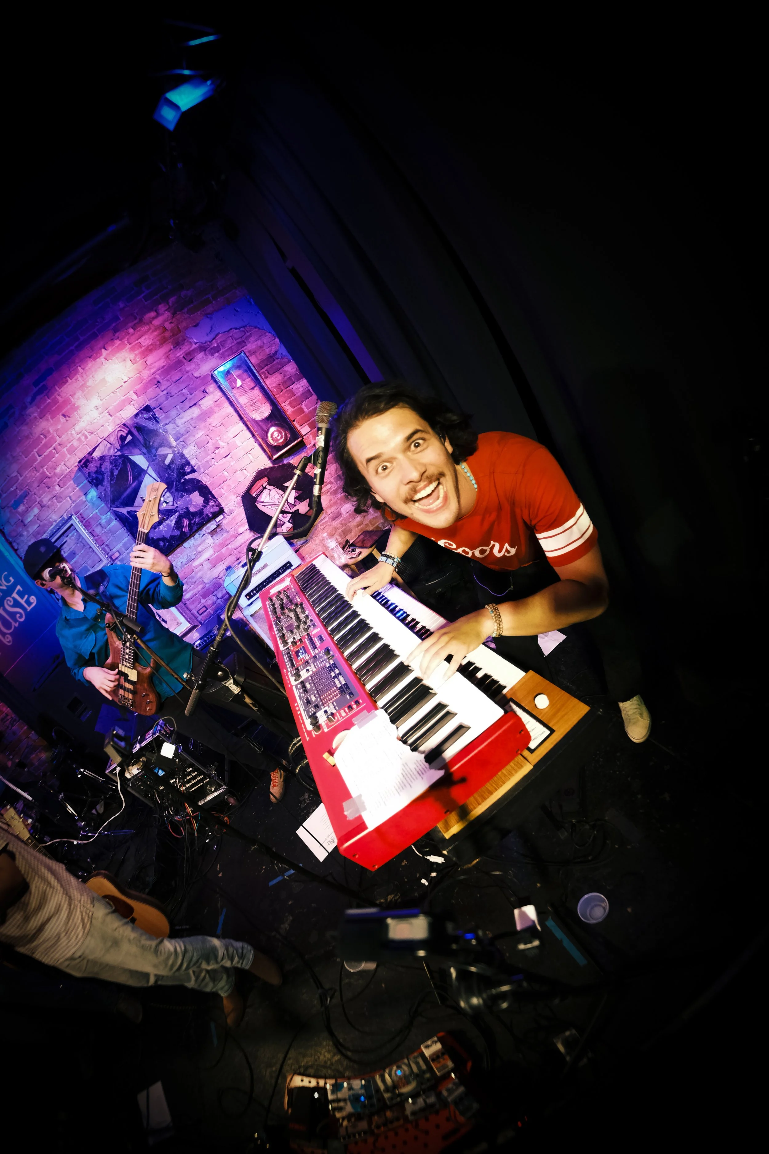 Joe May playing keyboard on stage