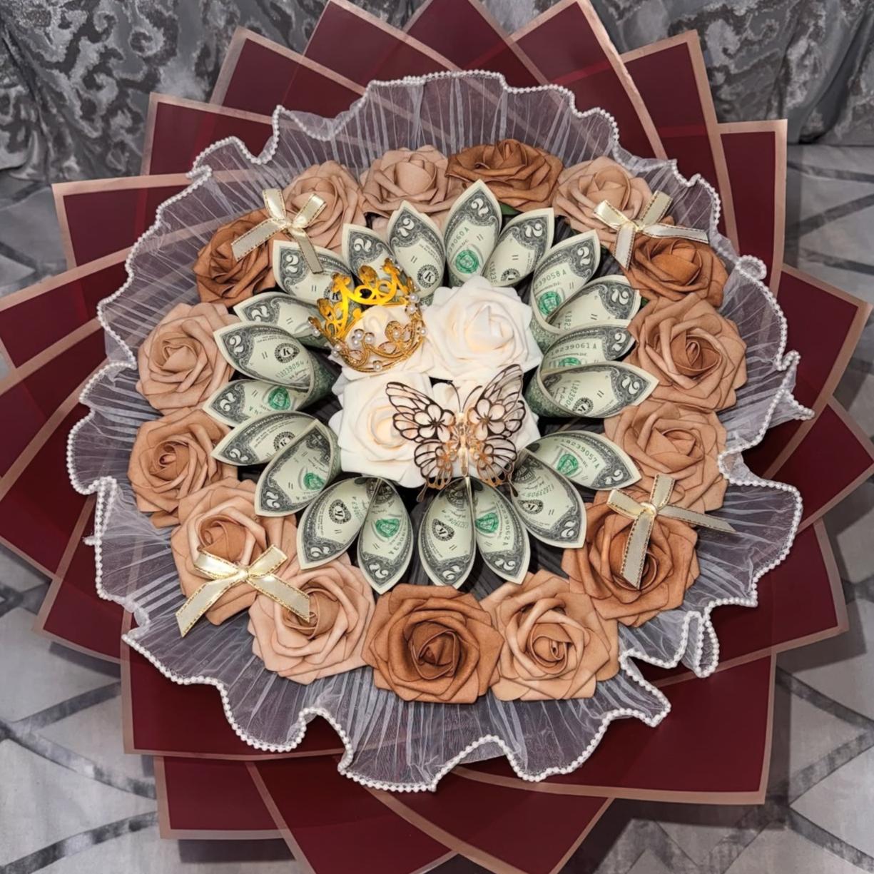 Money buquet made of folded one-dollar bills with gold butterfly decorations, a purple 