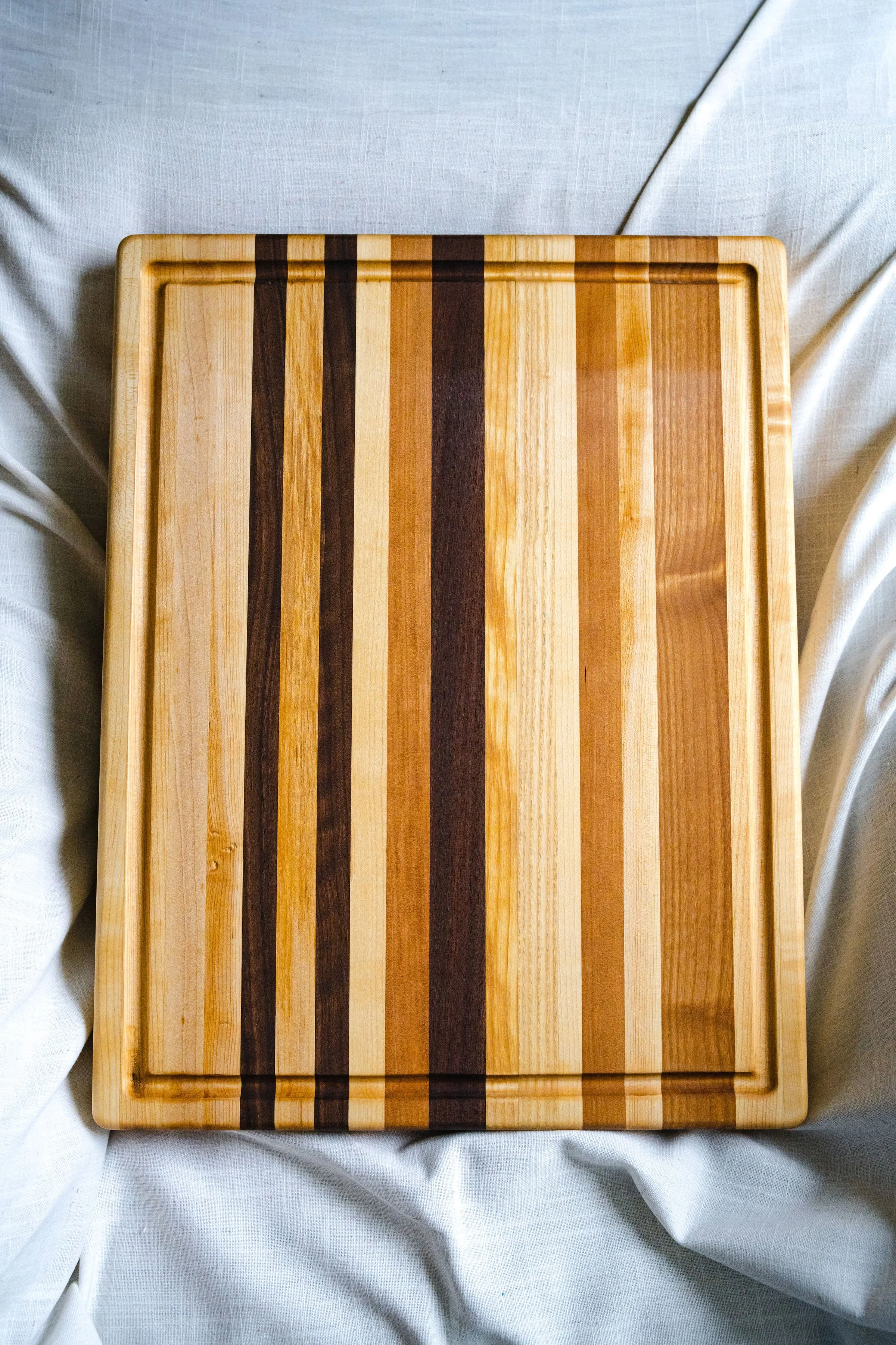 The Isabella Cutting Board - Maple focused w:highlights 2.jpg