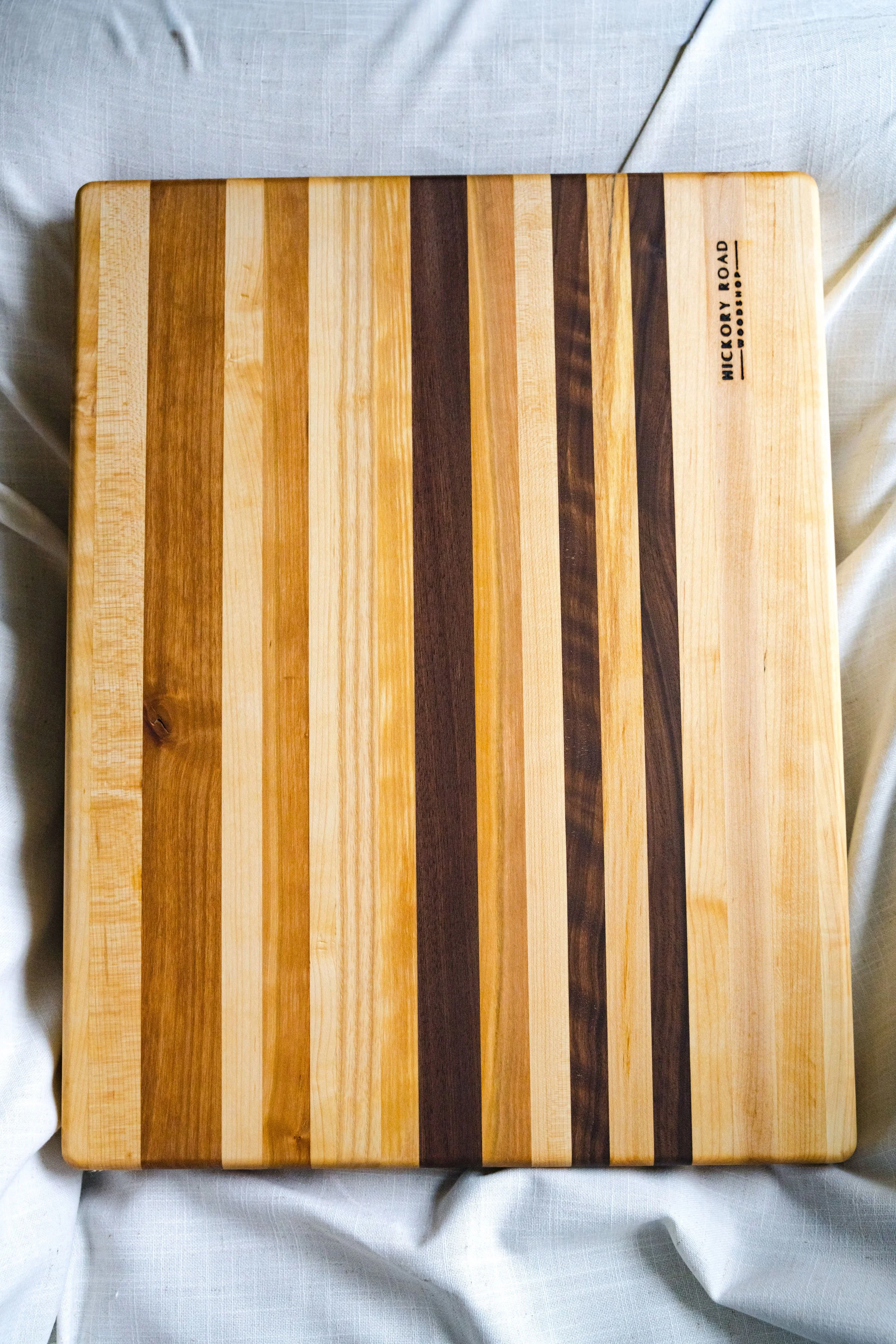 The Isabella Cutting Board - Maple focused w:highlights.jpg