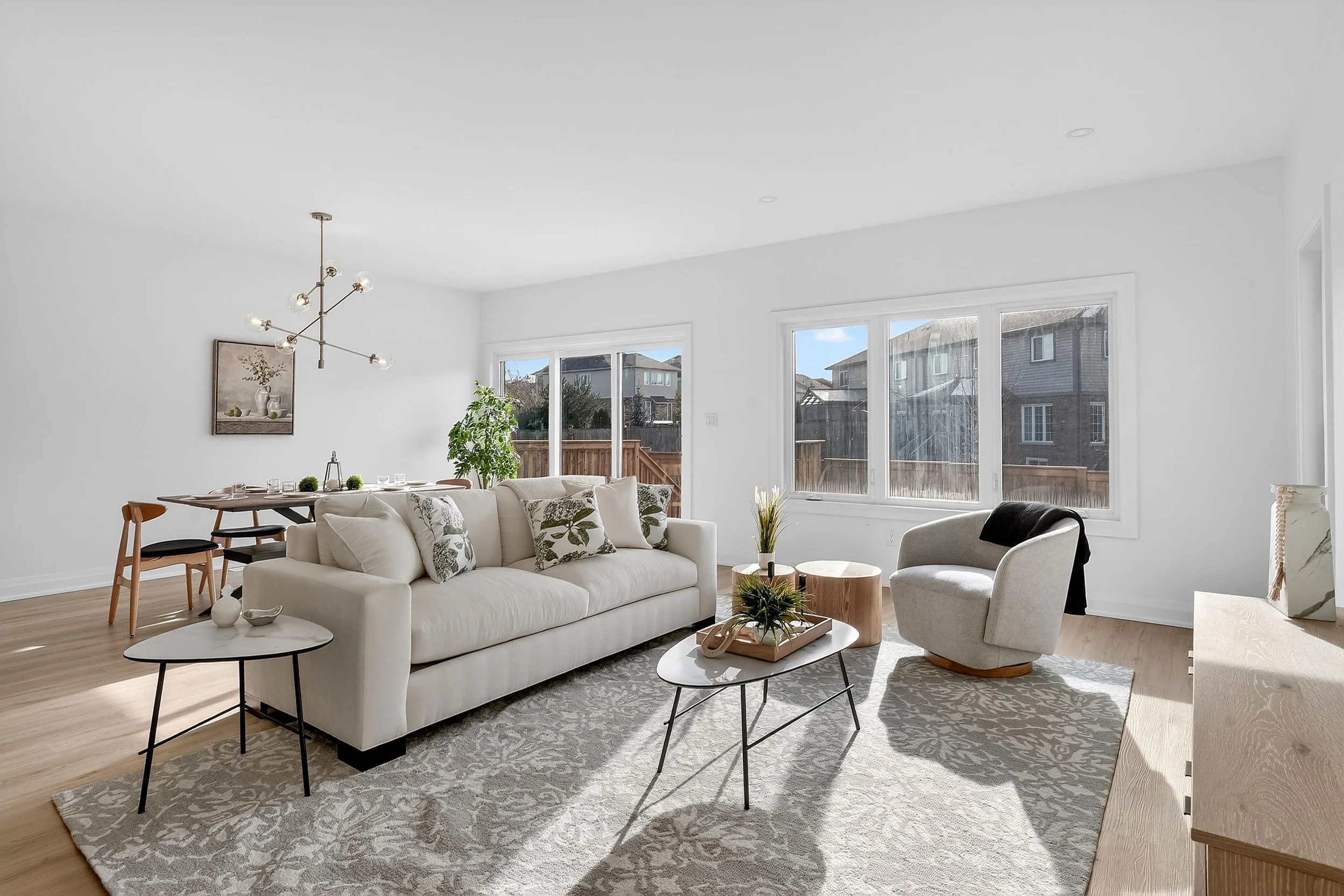 Custom Canadian made upholstered sofa in a bright, modern living room featuring neutral tones, natural light, and warm wood accents