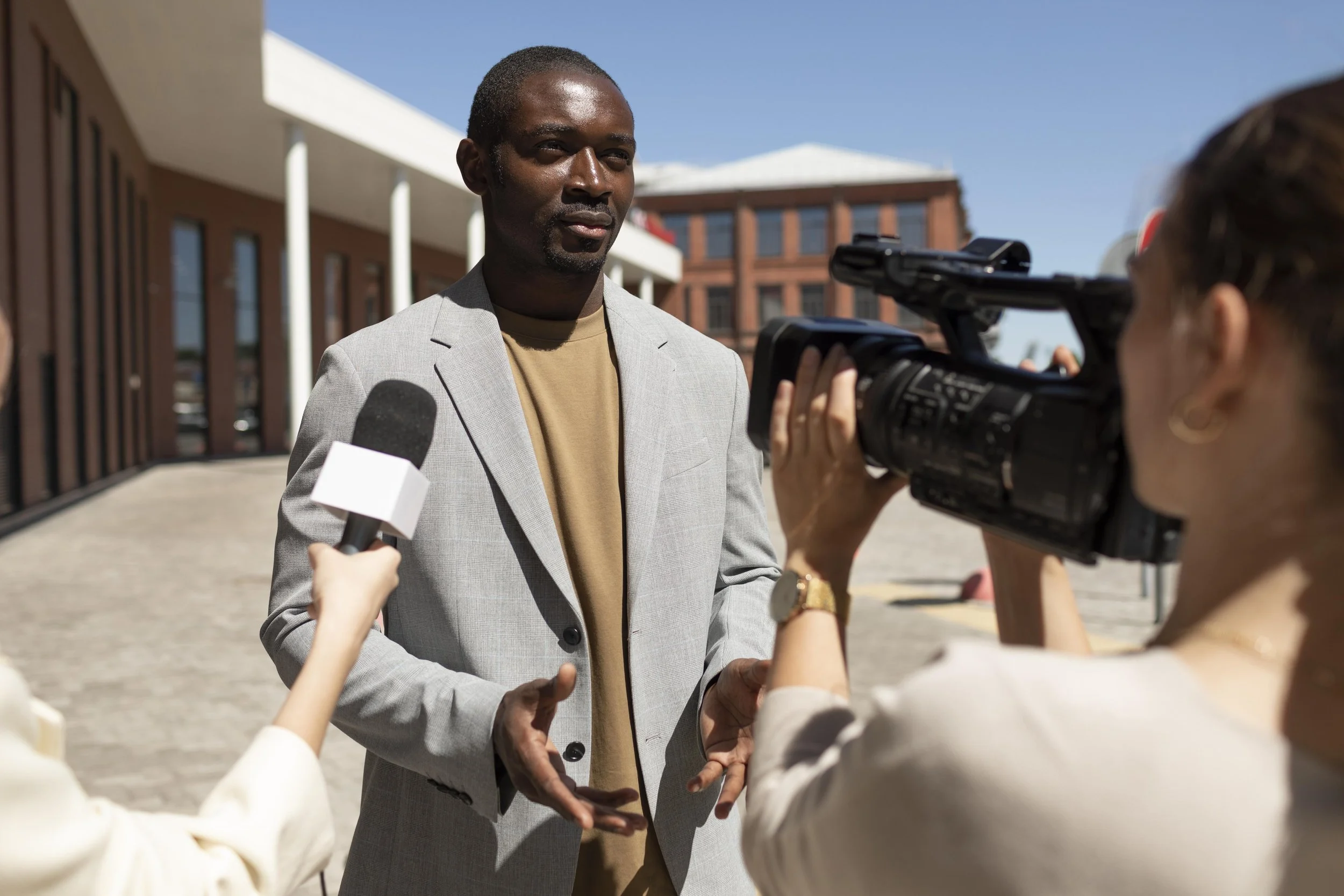 Man giving a statement into a microphone during a filmed interview, illustrating informed consent in ethical nonprofit storytelling
