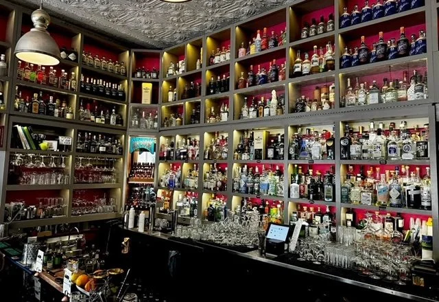 Gin Room's Back Bar with Bottles of Liquors Lining the Wall