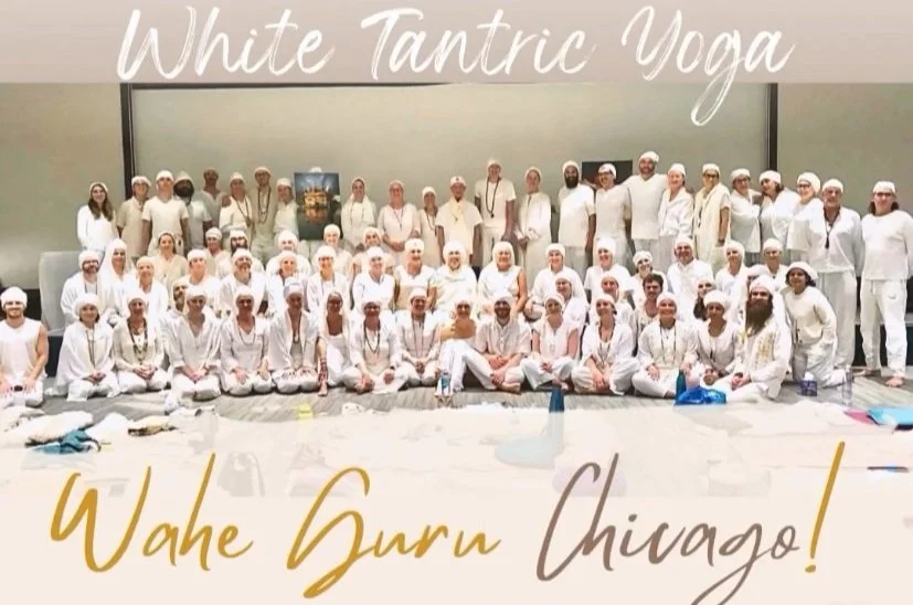 Group of people practicing white tantric yoga, all dressed in white, sitting and standing in a room with a plain background. The text overlay reads 'White Tantric Yoga' and 'Wahe Guru Chicago!'.