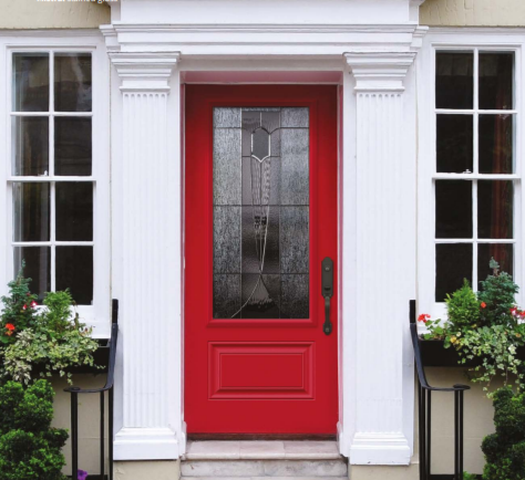 Red front door with decorative glass panel, flanked by two large windows, with potted plants on either side.