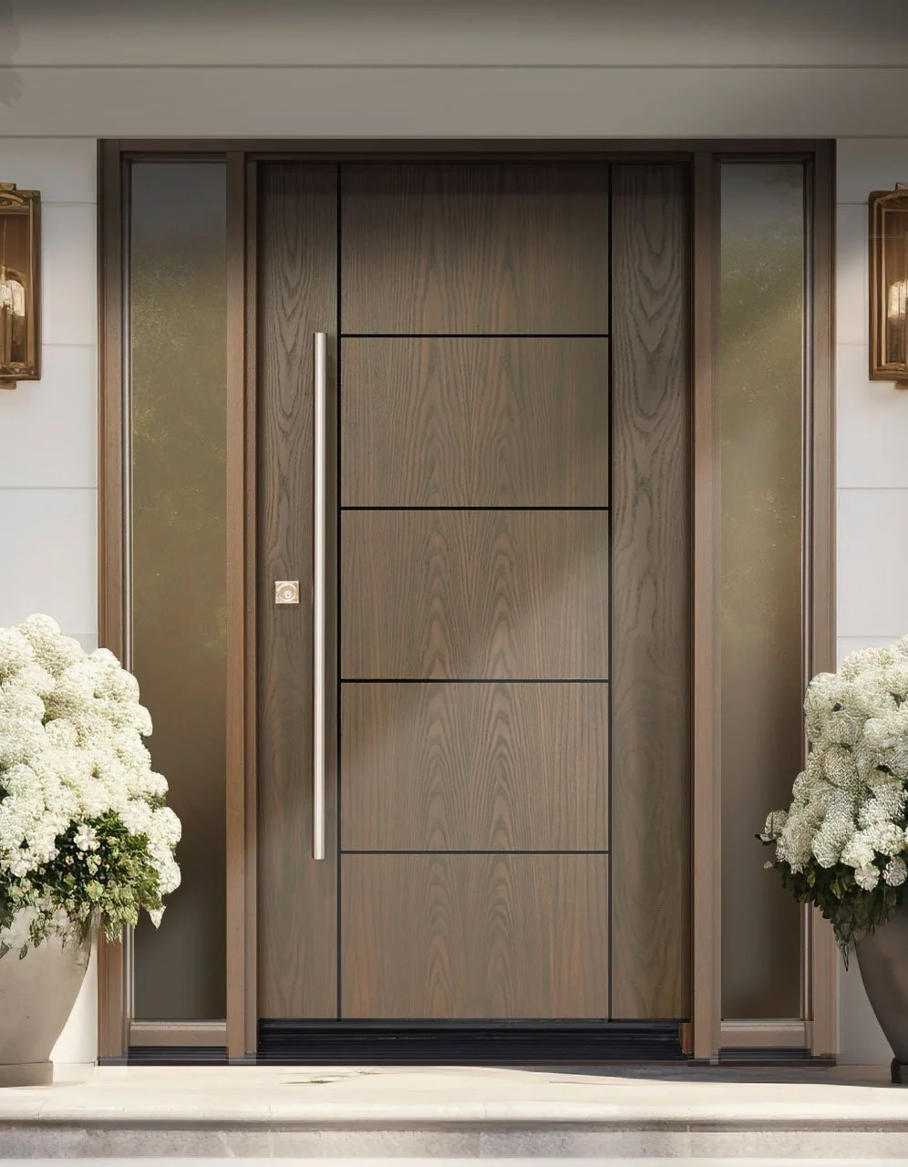 Modern front door with vertical wood panels and a tall, slim metallic handle, flanked by side glass panels, surrounded by white walls and two large potted white flower arrangements.