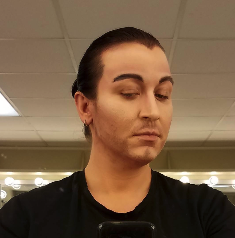 Masculine hairline, brows, and beard stubble.