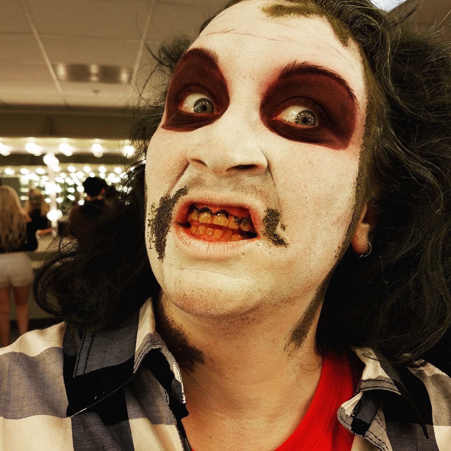 Makeup, hair color, beard stubble, tooth color.