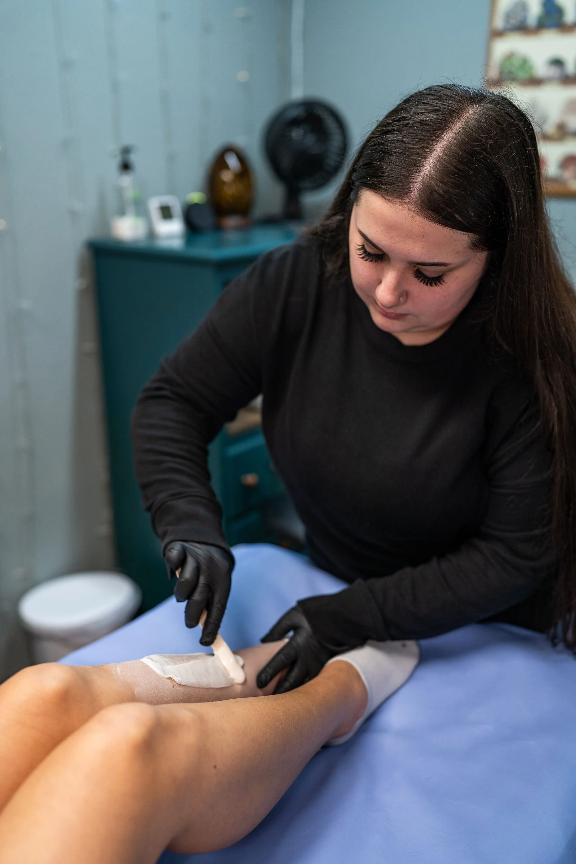 Kayla performing a leg waxing service at Maxwell’s Salon & Spa in Olympia, WA