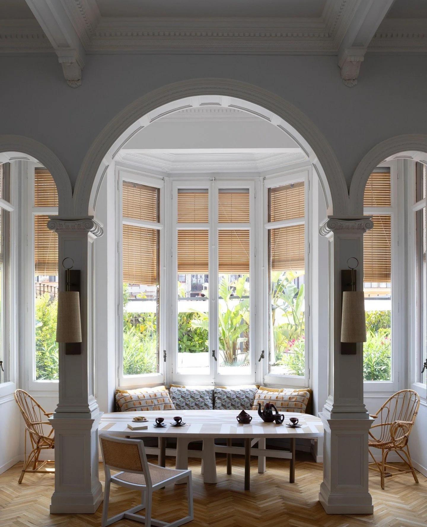 The relaxed holiday home of Atelier Tortil founder, Jean-Pierre Tortil and Didier Gomez in Barcelona features several pieces by the designer, including the 'Wood' dining table and 'Taboo' dining chair in the foreground here.⁠
⁠
The Atelier Tortil col